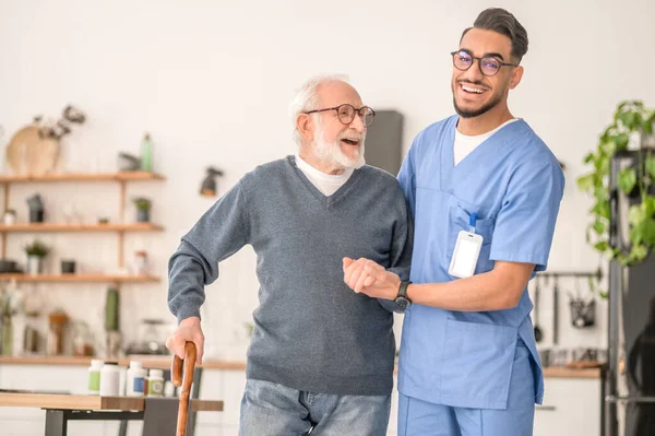 Veltia Care nurse supporting an elderly patient with a warm smile